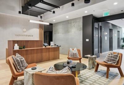 Modern reception desk with wooden slat paneling and Industrious branding.