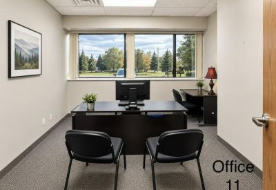 Private office suite with a desk facing a window and two guest chairs.