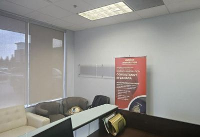 Modern reception desk with a dark wood finish and a large informational banner.