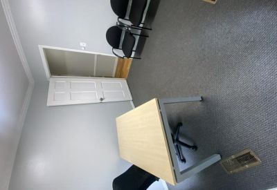Internal private office suite with a wooden desk and visitor seating.