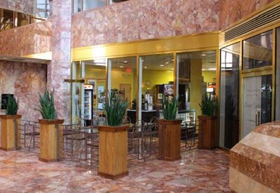 Lobby area with indoor plants and marble floor.