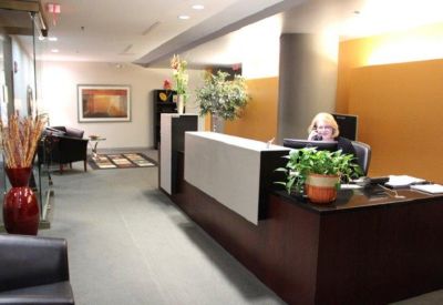 Reception desk area with a welcoming plant arrangement.
