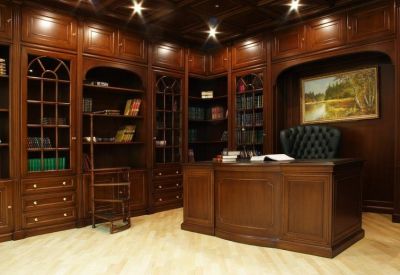 Private office featuring ornate dark wood cabinetry, a large executive desk, and leather chair.