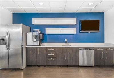 Breakroom kitchen featuring a blue accent wall and stainless steel appliances.