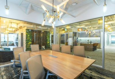 Contemporary meeting room with a large wooden table, designer lighting, and a living green wall.