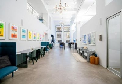 Spacious communal lounge with colorful art and various seating options.