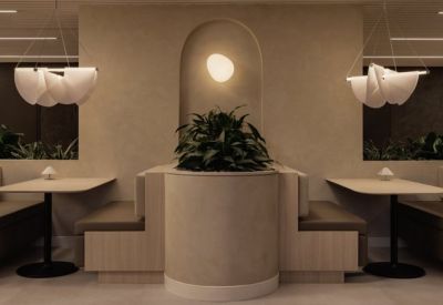 Cozy booth seating area with arched wall decor and warm lighting