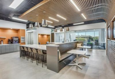 Breakout area with a large island counter, bar seating, and a decorative wood-slat ceiling.