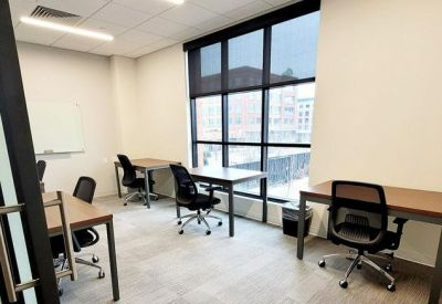 Four-person private office suite with large windows and city views.