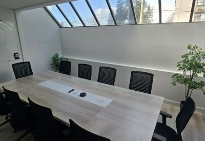 Conference room with skylight and greenery.