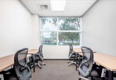 Private office with four desks and a large window at 6203 San Ignacio Avenue, Suite 110.