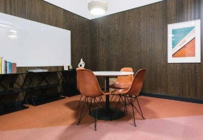 Private meeting room with wood-paneled walls, a white table, and leather chairs.