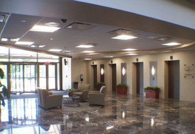 Spacious building lobby with polished marble floors and comfortable seating areas.