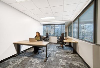 Private office space with large windows and two individual workstations.