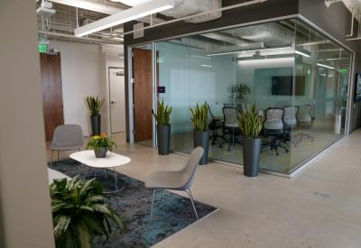 Private phone booth or focus room with an armchair and colorful wall art.