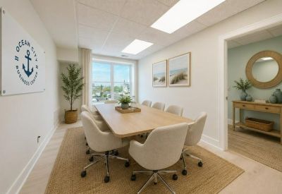 Professional conference room with a large wooden table and nautical wall art.