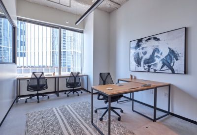 Private office with two desks and abstract artwork.
