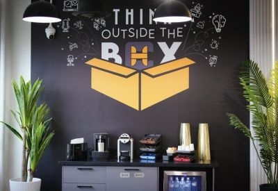 Kitchenette area with a chalkboard wall featuring inspirational graphics.
