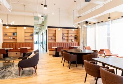 Spacious communal lounge with leather banquette seating and warm wood accents.