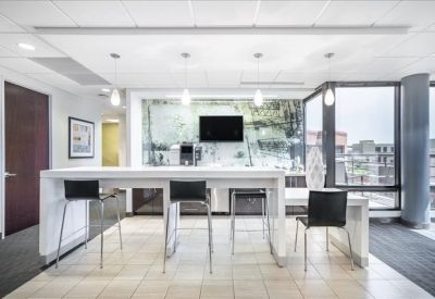 Breakout area with a white high-top table and view of the street.
