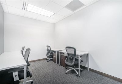 Internal office suite with three workstations and ergonomic chairs.