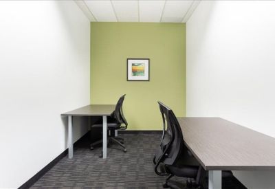 Two-person internal office suite with a green feature wall.