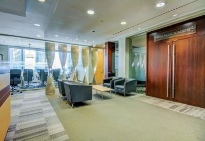 Spacious reception area with blue armchairs, a coffee table, and large decorative privacy screens.