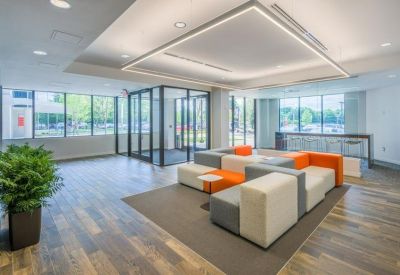 Bright lobby area with contemporary orange and grey modular seating.