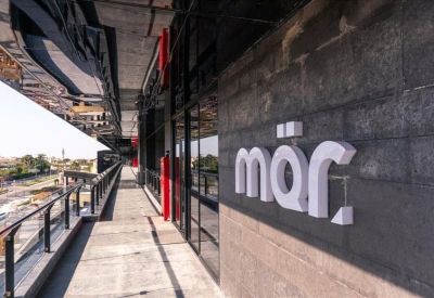 Spacious dual-desk private office with large windows overlooking trees.