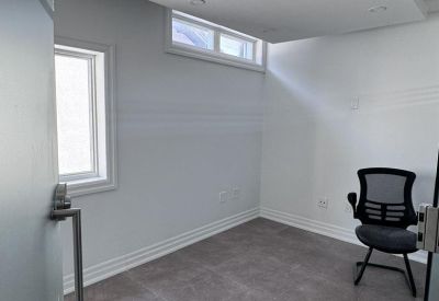 Communal kitchen area with a sink and white countertops.