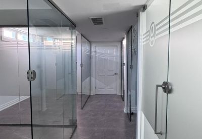 Spacious glass-walled meeting area with tiled flooring.