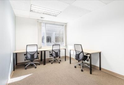 Communal kitchen area featuring modern grey cabinetry and stainless steel appliances.