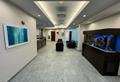 Reception area featuring a large built-in aquarium and abstract wall art.