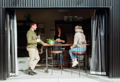 Coworking space entrance with guests seated at a high-top table.