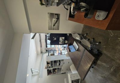 Private office workspace with wooden desk and white shelving.