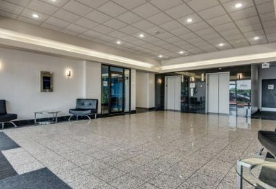 Spacious lobby with polished stone flooring and modern seating areas.