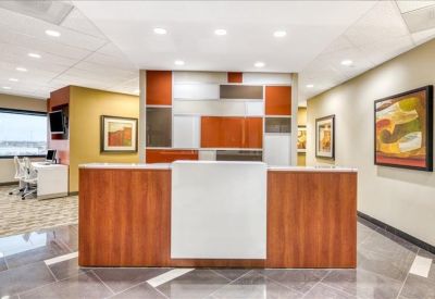 Professional reception desk with wood paneling and a colorful geometric feature wall.