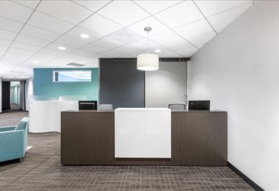 Professional reception area with a dark wood and white front desk.