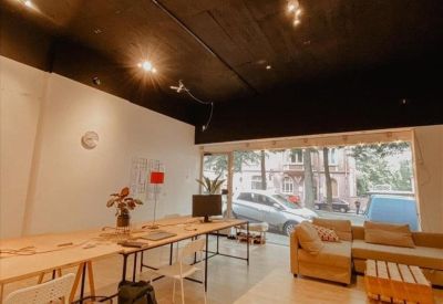 Bright private office with an L-shaped desk and large window.