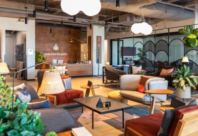 Reception area with wood-paneled walls, warm lighting, and plush lounge seating.