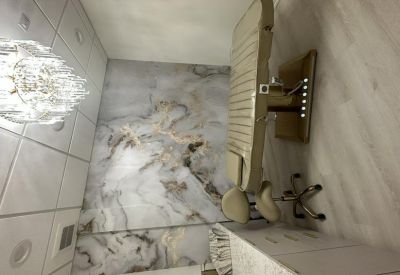 Upscale treatment room with integrated lighting on the base of the spa bed.