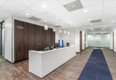 Modern reception area with a white desk and wood-slat feature wall.