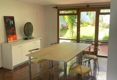 Meeting area with a light wood table and view of the backyard.
