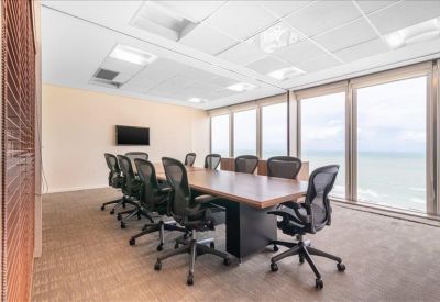 Conference room with a large wooden table and views overlooking the coast.
