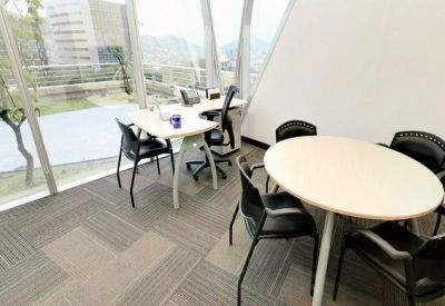 Bright corner office with two workstations and floor-to-ceiling windows.