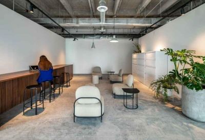 Sleek reception area with a long wooden counter and lounge seating.