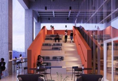 Amphitheater-style seating and orange staircase in a modern breakout area.