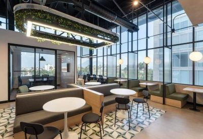Vibrant communal area at Avenida de la juventud #100, THINK Workspace featuring booth seating and greenery.