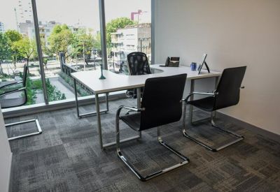 Two-person private office with floor-to-ceiling windows.