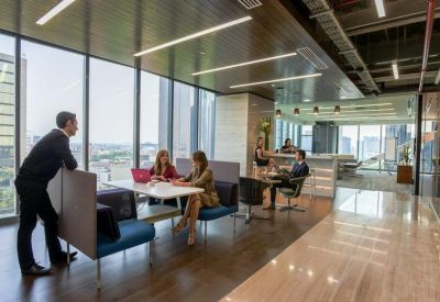 Open workspace with people collaborating around tables.